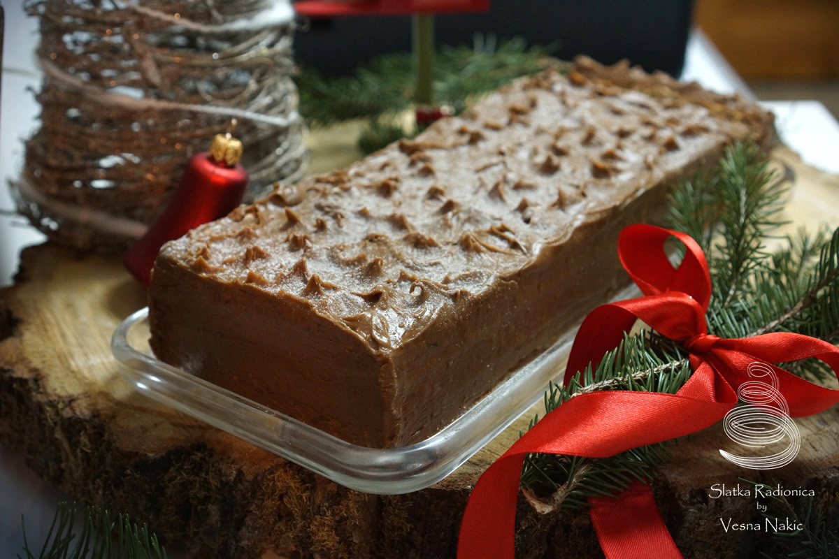 Mamina torta s datuljama servirana na drvenoj podlozi s blagdanskim detaljima u zeleno-crvenim bojama